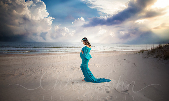 Maternity pose, profile looking towards water