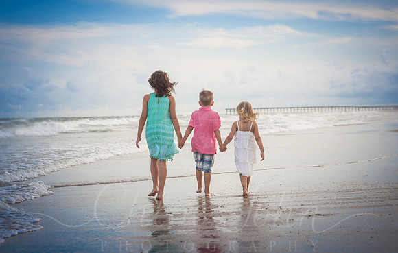 - Siblings walking down the beach